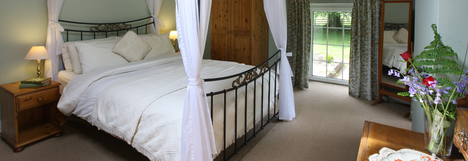 Four poster bed at Swansea Valley Holiday Cottages on the Plas Cilybebyll Estate